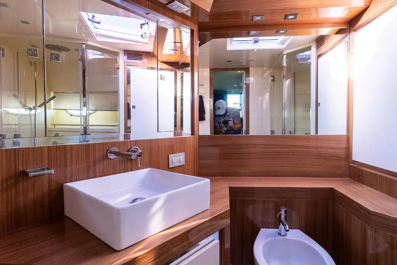 Balliamo Yacht Photos Pics Luxurious bathroom interior of 2011 Uniesse 55S yacht with modern fixtures and wood accents.