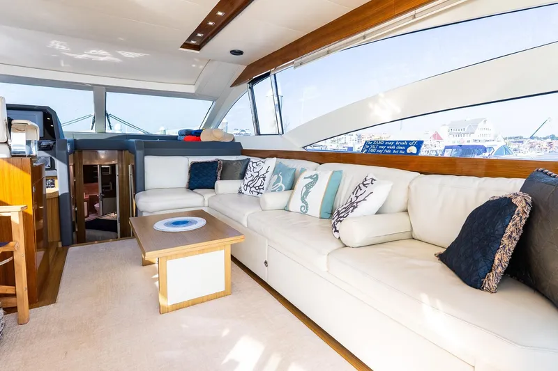 Balliamo Yacht Photos Pics Luxurious interior of 2011 Uniesse 55S yacht with elegant white seating and decorative pillows.