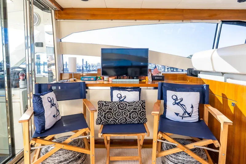 Balliamo Yacht Photos Pics Luxurious 2011 Uniesse 55S yacht interior with nautical-themed decor and comfortable seating.