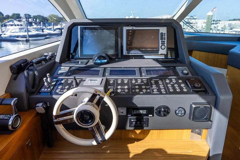 Balliamo Yacht Photos Pics Cockpit of 2011 Uniesse 55S yacht with advanced navigation controls and steering wheel.