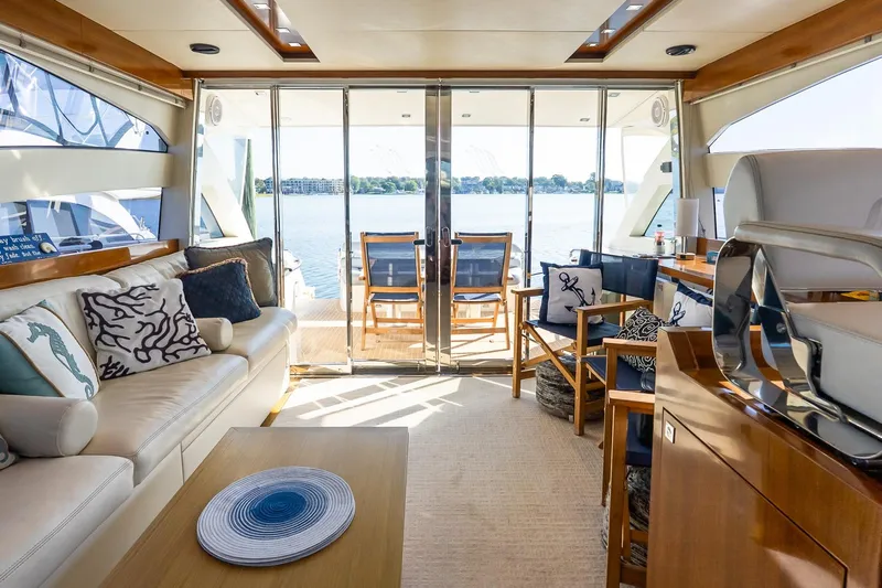 Balliamo Yacht Photos Pics Luxurious interior of 2011 Uniesse 55S yacht with elegant seating and scenic water view.