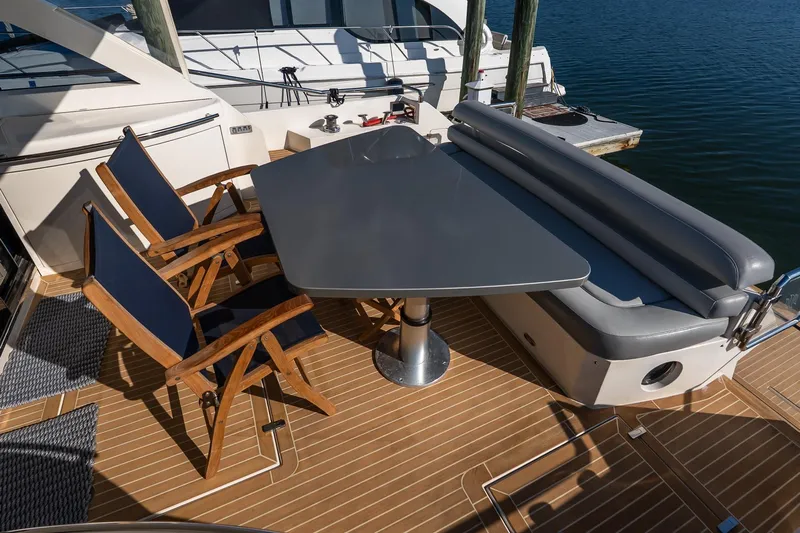 Balliamo Yacht Photos Pics Outdoor seating area on 2011 Uniesse 55S yacht with table and chairs.