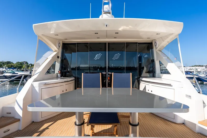 Balliamo Yacht Photos Pics Luxury 2011 Uniesse 55S yacht with sleek outdoor dining area and marina view.