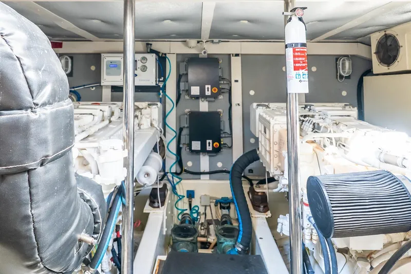 Balliamo Yacht Photos Pics Engine room of 2011 Uniesse 55S yacht with visible machinery and fire extinguisher.