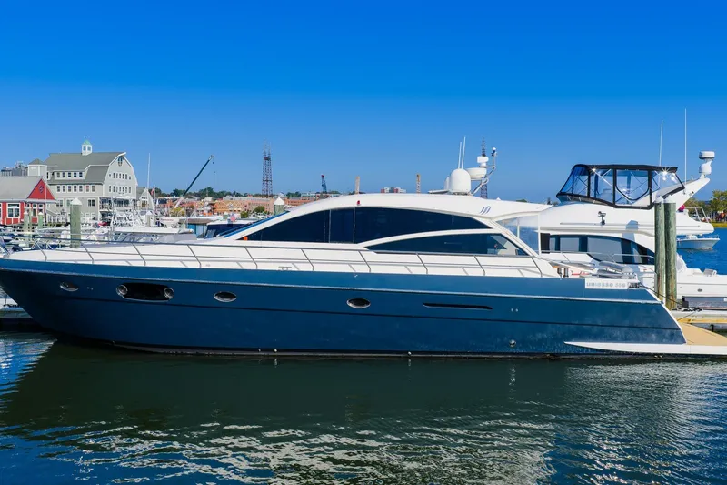 Balliamo Yacht Photos Pics Luxury 2011 Uniesse 55S yacht docked at a marina under clear blue skies.