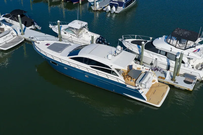 Balliamo Yacht Photos Pics 2011 Uniesse 55S yacht docked at marina, surrounded by other boats.