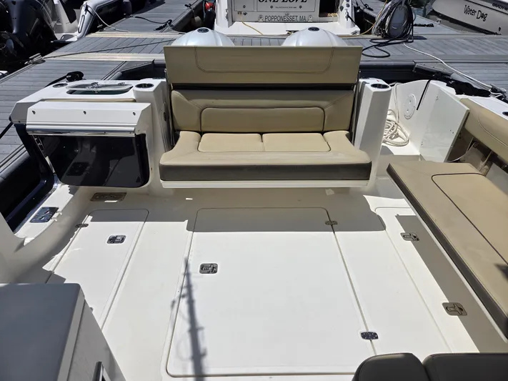 First Mate Yacht Photos Pics 2020 Pursuit DC 326 Dual Console boat interior with beige seating and spacious deck.