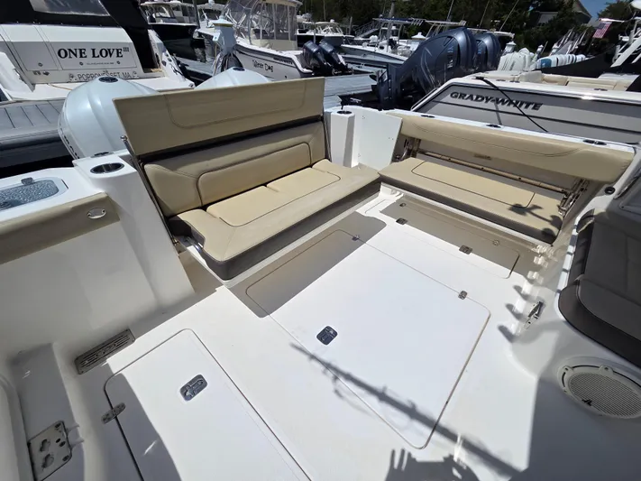 First Mate Yacht Photos Pics 2020 Pursuit DC 326 Dual Console boat with beige seating and spacious deck area.