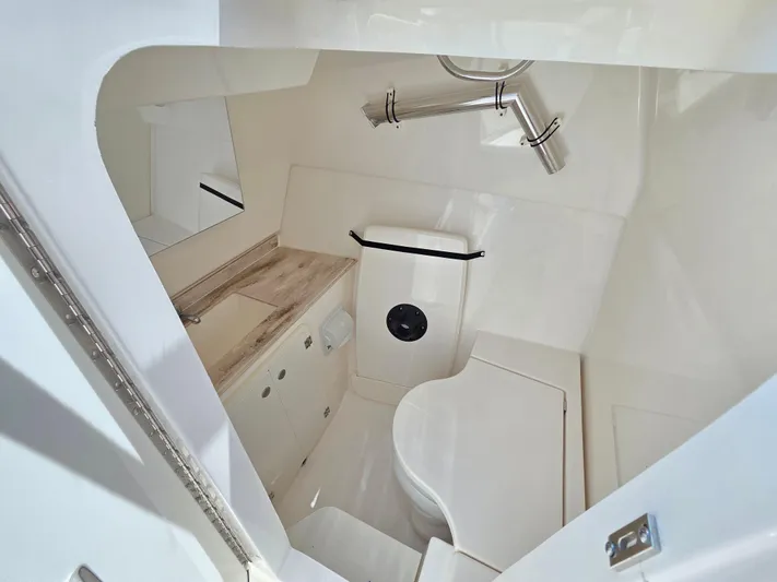 First Mate Yacht Photos Pics 2020 Pursuit DC 326 Dual Console boat interior with compact bathroom amenities.