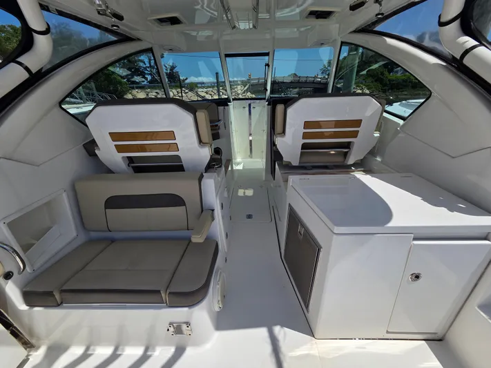 First Mate Yacht Photos Pics 2020 Pursuit DC 326 Dual Console interior with seating and storage compartments.