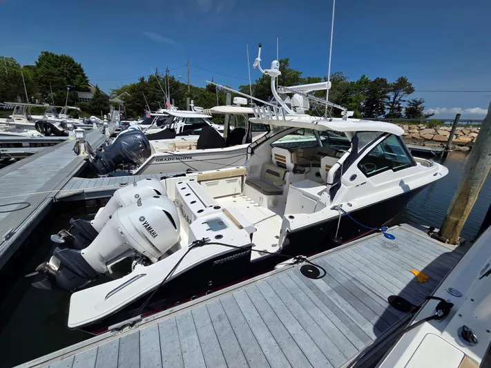 First Mate Yacht Photos Pics 2020 Pursuit DC 326 Dual Console boat docked with twin Yamaha engines.