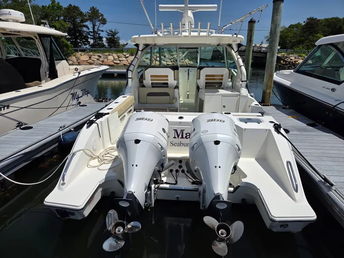 First Mate Yacht Photos Pics 2020 Pursuit DC 326 Dual Console boat docked with twin outboard engines.