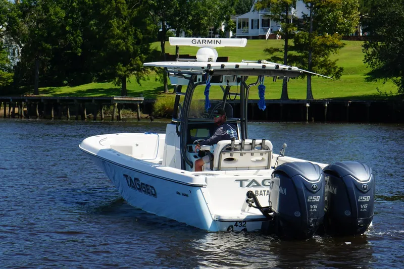 Tagged Yacht Photos Pics 2023 Sea Born LX26 Center Console boat with dual Yamaha engines on a scenic waterway.