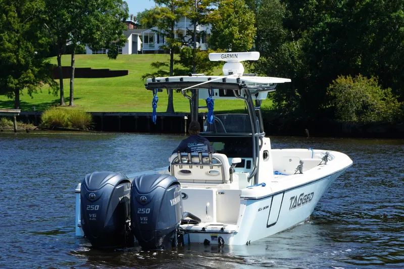 Tagged Yacht Photos Pics 2023 Sea Born LX26 Center Console boat on a scenic river with twin Yamaha engines.