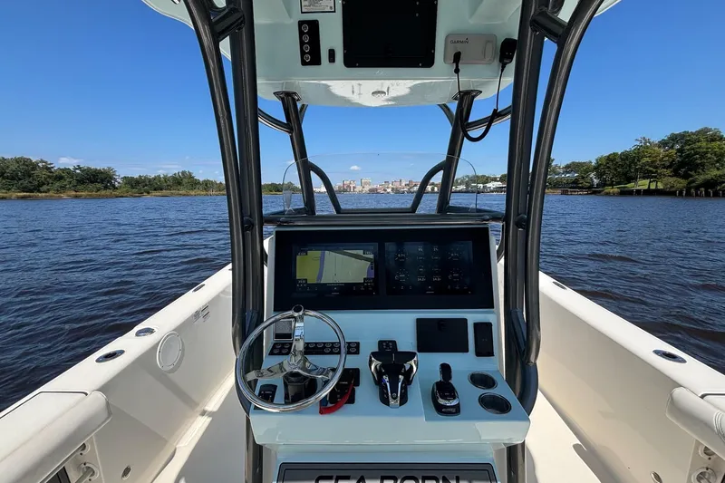 Tagged Yacht Photos Pics 2023 Sea Born LX26 Center Console boat dashboard on a sunny day, river view.