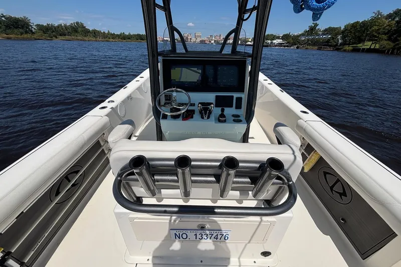 Tagged Yacht Photos Pics 2023 Sea Born LX26 Center Console boat interior with steering and control panel on water.