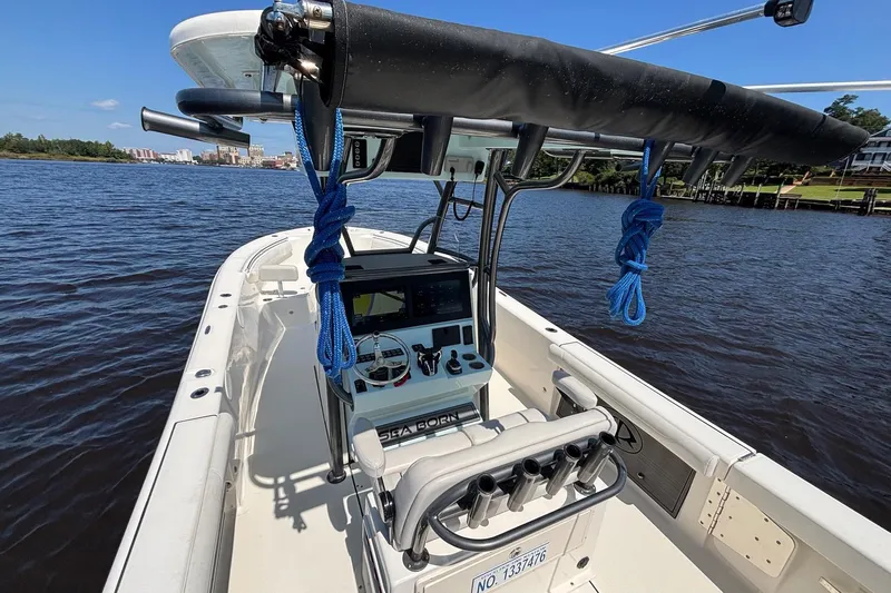 Tagged Yacht Photos Pics 2023 Sea Born LX26 Center Console boat on calm water, featuring modern navigation equipment.