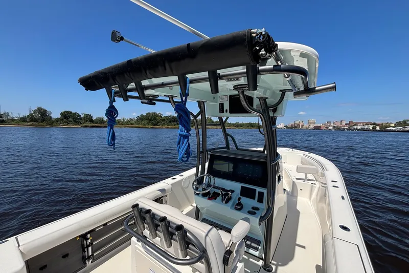 Tagged Yacht Photos Pics 2023 Sea Born LX26 Center Console boat on calm water, clear blue sky.