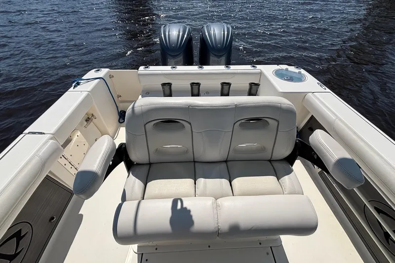 Tagged Yacht Photos Pics 2023 Sea Born LX26 Center Console boat interior with cushioned seating and dual engines.