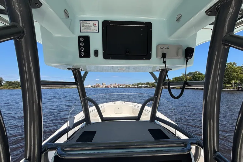 Tagged Yacht Photos Pics 2023 Sea Born LX26 Center Console boat on a scenic river with city skyline.