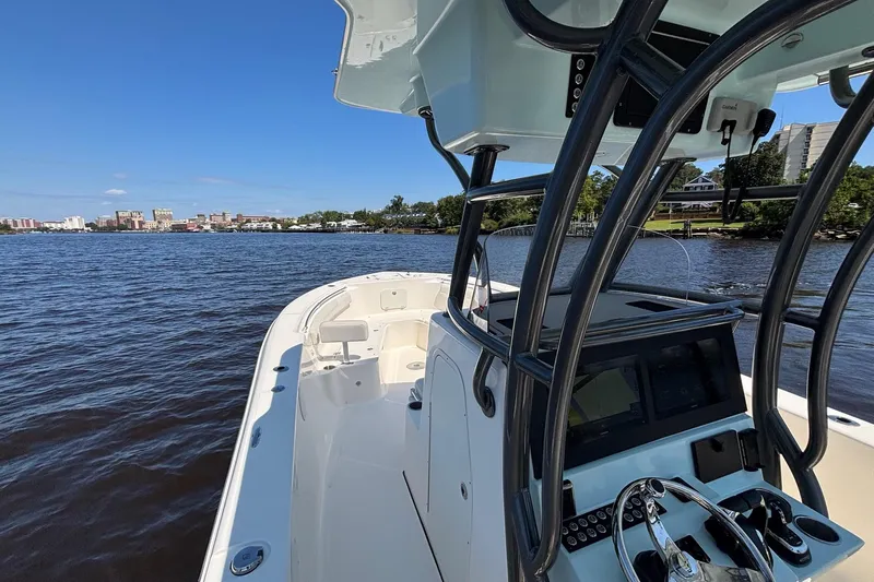Tagged Yacht Photos Pics 2023 Sea Born LX26 Center Console boat on calm water with cityscape in background.