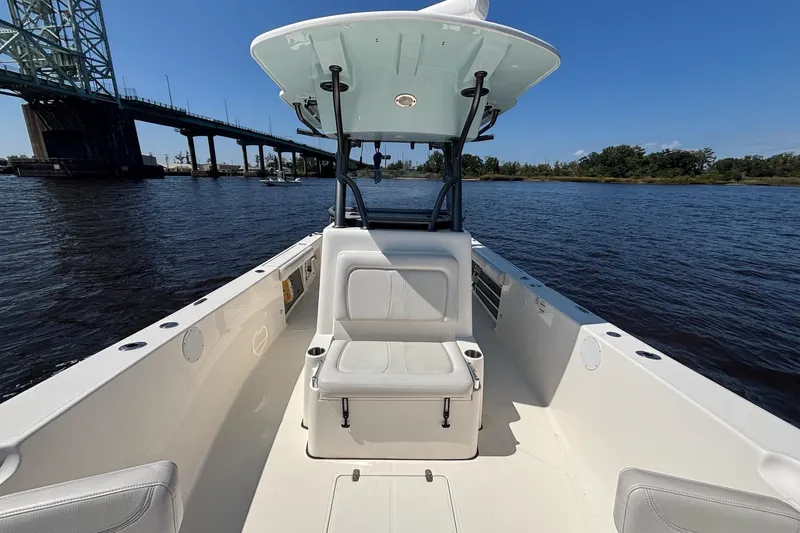 Tagged Yacht Photos Pics 2023 Sea Born LX26 Center Console boat on water near a bridge, clear sky.