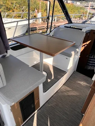  Yacht Photos Pics Interior of 2020 Jeanneau NC 895 boat with seating and table.