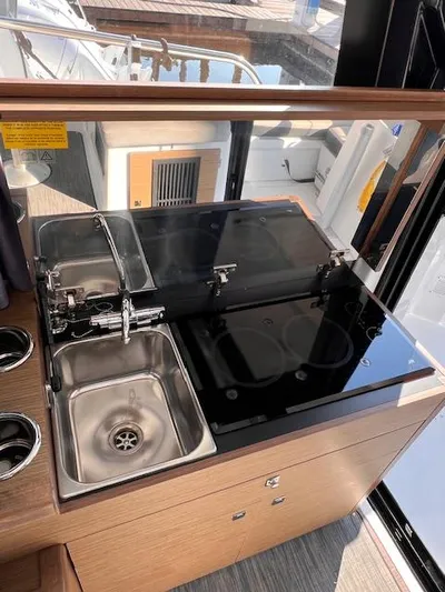  Yacht Photos Pics 2020 Jeanneau NC 895 boat kitchen with sink and stove.