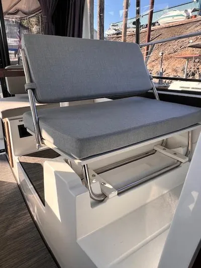  Yacht Photos Pics 2020 Jeanneau NC 895 boat interior with gray cushioned seating.