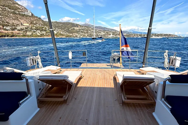  Yacht Photos Pics Luxurious Dereli S/Y 39 m yacht deck with sun loungers, scenic coastal view, 2004 model.