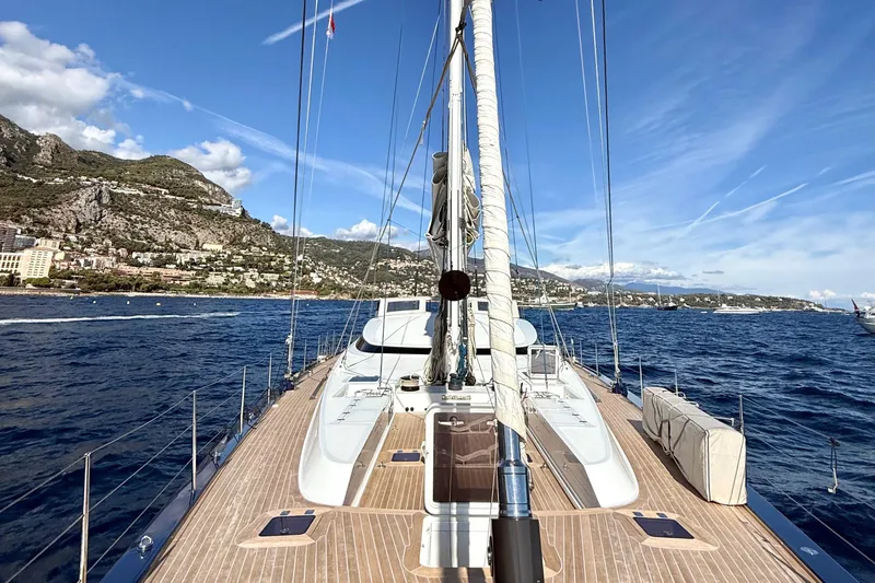  Yacht Photos Pics Deck view of 2004 Dereli S/Y 39 m yacht sailing near scenic coastline.