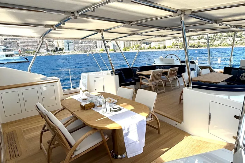  Yacht Photos Pics Luxurious 2004 Dereli S/Y 39 m yacht deck with elegant dining area and ocean view.