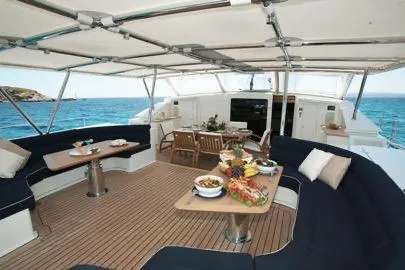  Yacht Photos Pics Luxurious 2004 Dereli Yachts S/Y 42 m deck with elegant dining setup and ocean view.
