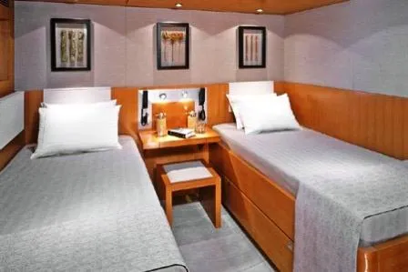  Yacht Photos Pics Luxurious twin cabin in 2004 Dereli Yachts S/Y 42 m, featuring elegant wood finishes.