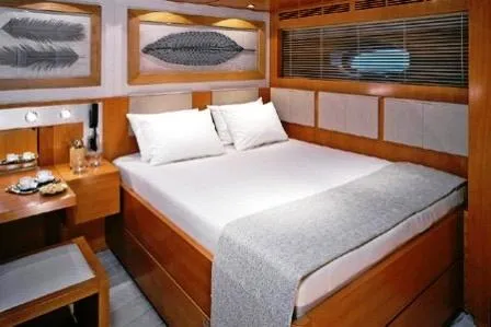  Yacht Photos Pics Luxurious yacht bedroom with modern design, featuring a cozy bed and elegant decor.