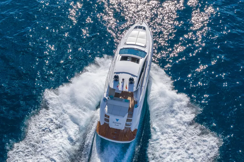 Filippetti S55 Yacht Photos Pics Aerial view of 2025 Filippetti Sport 55 yacht cruising on blue ocean waters.