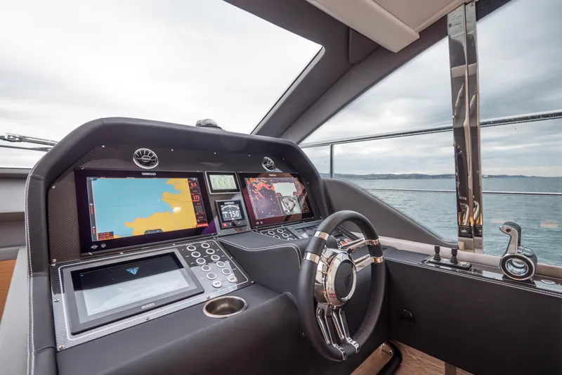 Filippetti S55 Yacht Photos Pics Control panel of 2025 Filippetti Sport 55 yacht with navigation screens and steering wheel.
