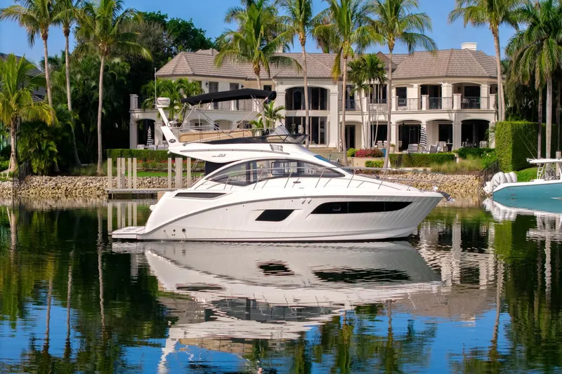 Our Journey Yacht Photos Pics 2017 Sea Ray 400 Fly yacht docked by luxury waterfront mansion.
