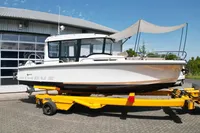 2021 Nimbus C8 boat on a yellow trailer, parked outside a building.