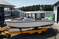 2021 Nimbus C8 boat on trailer outside a garage, showcasing sleek design and modern features.