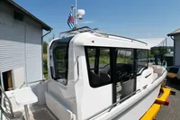 2021 Nimbus C8 boat with sleek design, docked outdoors under clear blue sky.