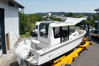 2021 Nimbus C8 boat on trailer, parked outdoors near building.