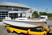 2021 Nimbus C8 boat on a yellow trailer, parked outside a building.