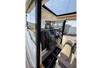 Interior view of 2021 Nimbus C8 boat, featuring modern helm and seating.