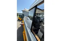 2021 Nimbus C8 boat interior with forklift nearby, showcasing modern design and controls.
