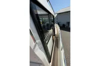 Side view of 2021 Nimbus C8 boat with sleek design and wooden deck.
