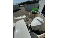 2021 Nimbus C8 boat with Mercury engine, docked near shipping containers.
