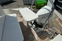 Boat deck of 2021 Nimbus C8 with Mercury engine, featuring seating and table.