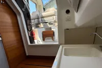 Interior of 2021 Nimbus C8 boat featuring seating and a compact sink area.