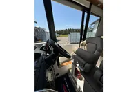 Interior view of 2021 Nimbus C8 boat cockpit with steering wheel and comfortable seating.